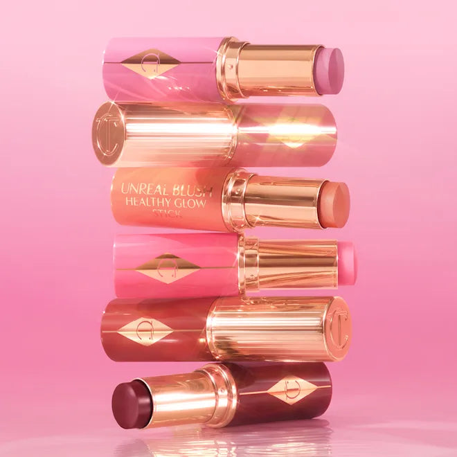 CHARLOTTE TILBURY  UNREAL LIP + CHEEK GLOW BLUSH STICK WITH HYALURONIC ACID (PEACHY GLOW)